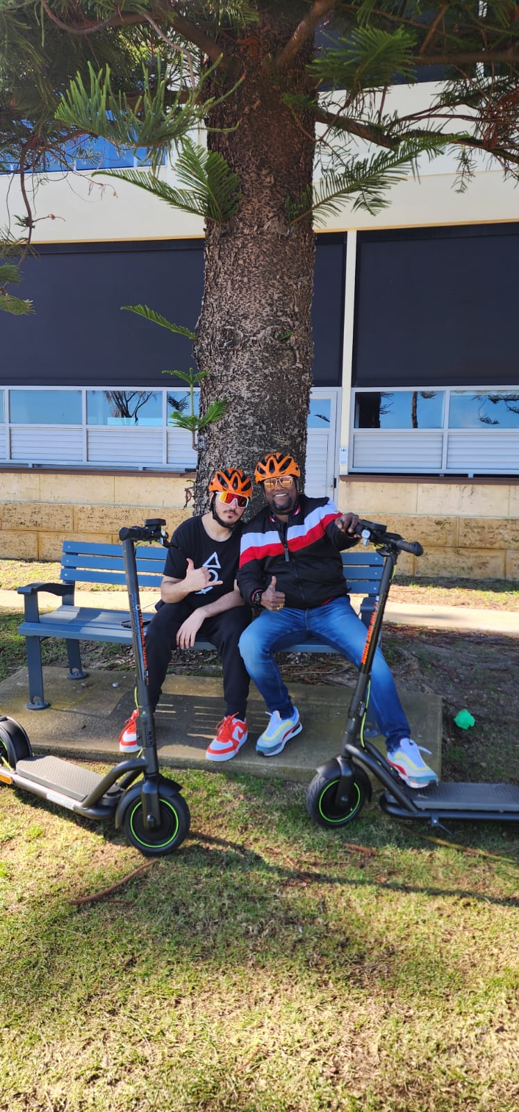 A worker and a teenager resting after an e-scooter ride