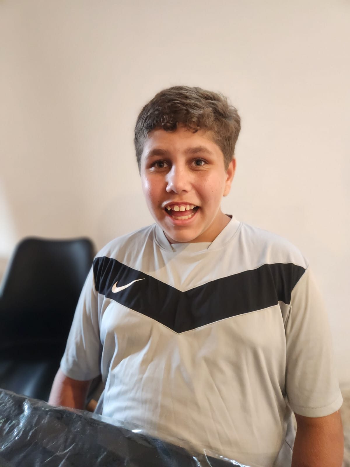 A smiling teenager supported by Vel Care Alliance